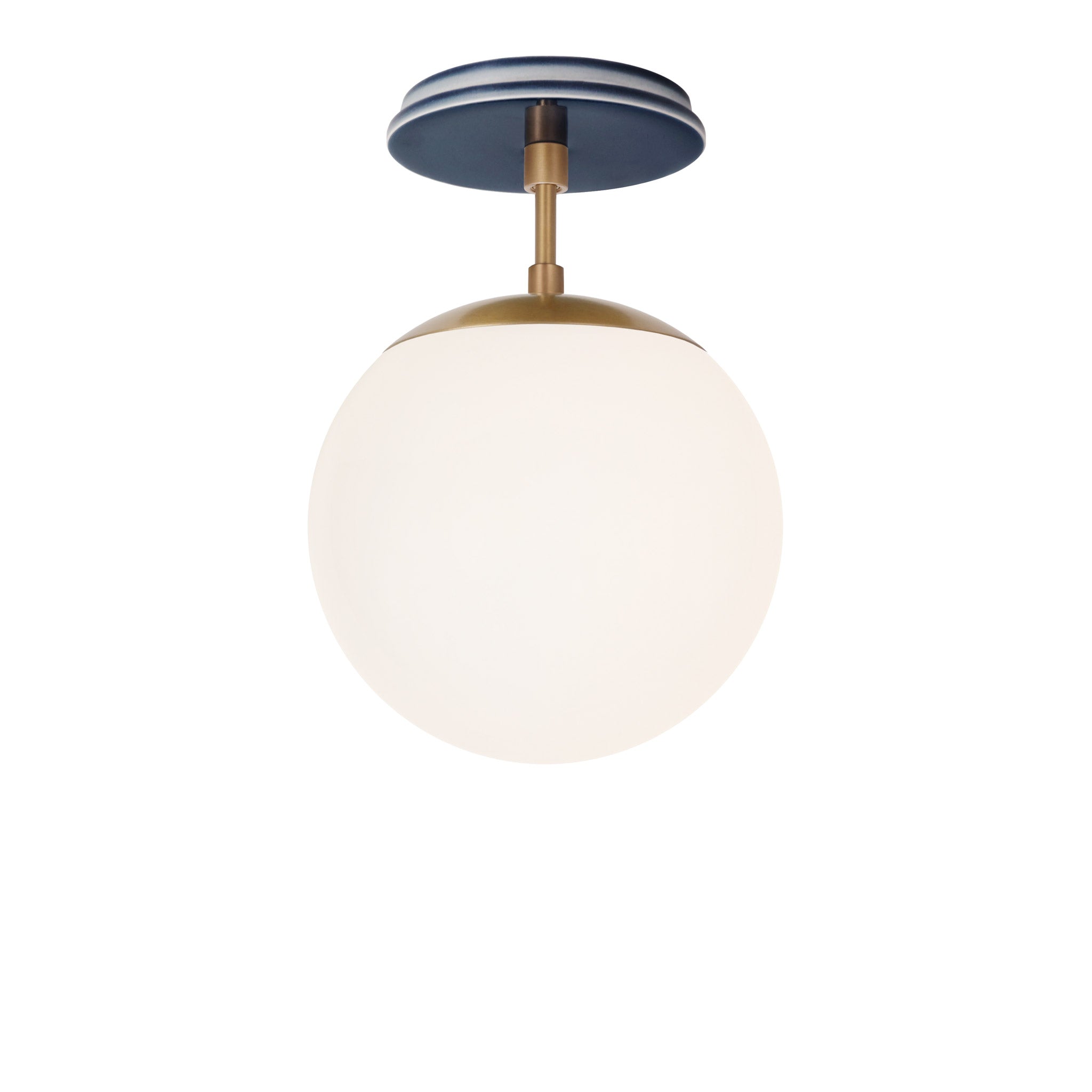 Alto Surface 8" shown in Heirloom Brass with an Indigo Blue Swift Ceramic Canopy
