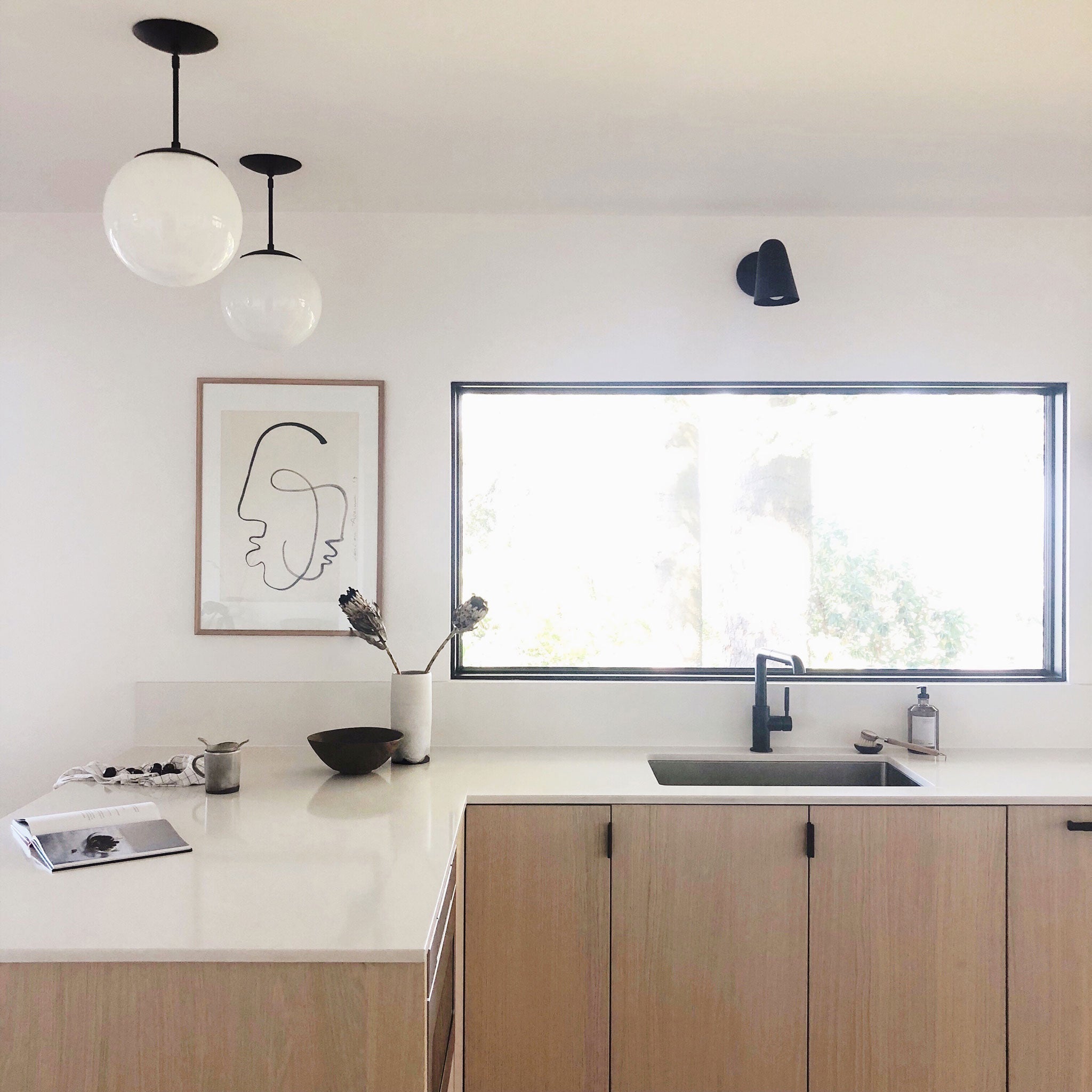 Wildwood with Wood Canopy shown in Matte Black. Interior Design by Courtney Nye Design