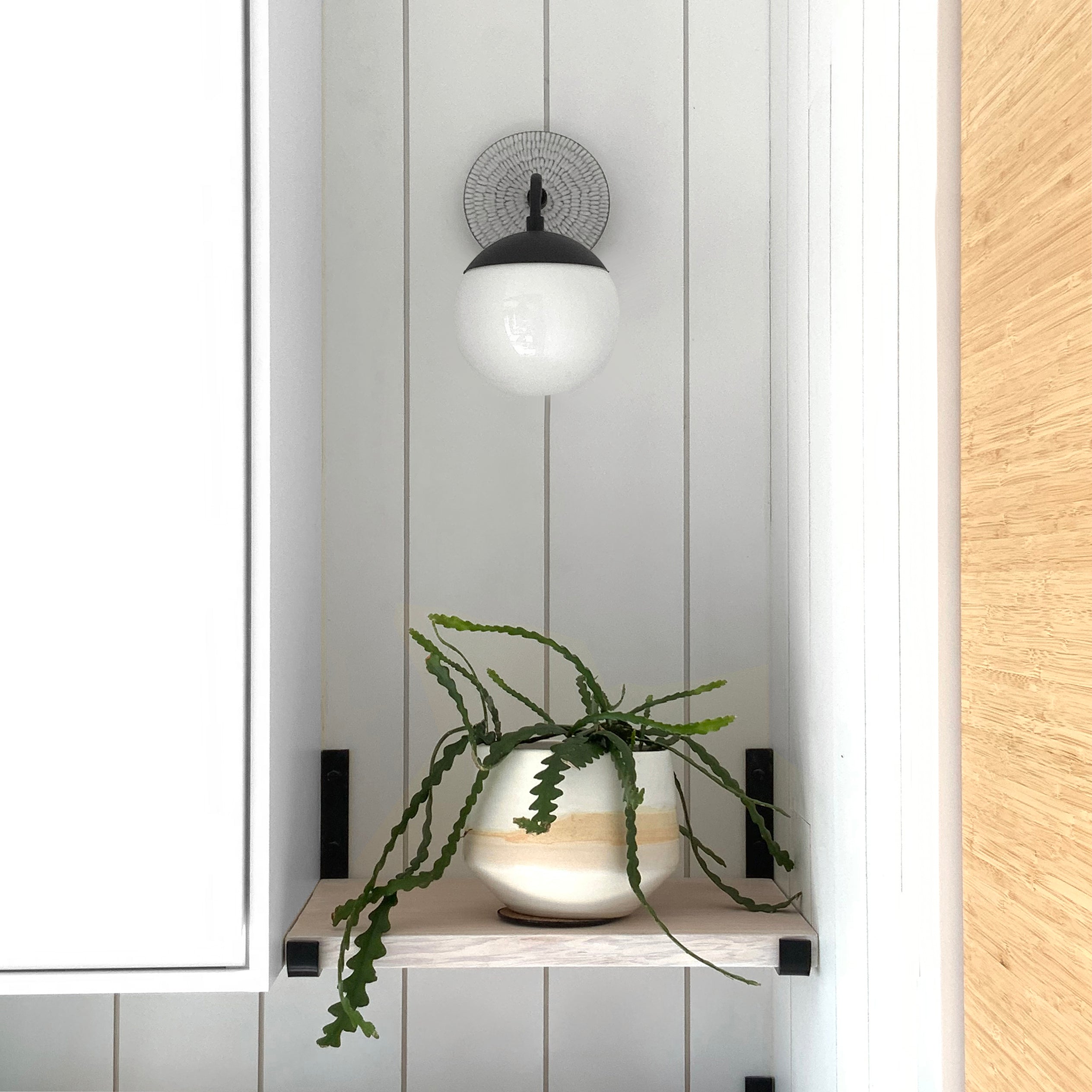 Alto Sconce 6" shown in Matte Black with a Brownstone White Sunflower Ceramic Canopy. Interior Design by Alison Vercruysse