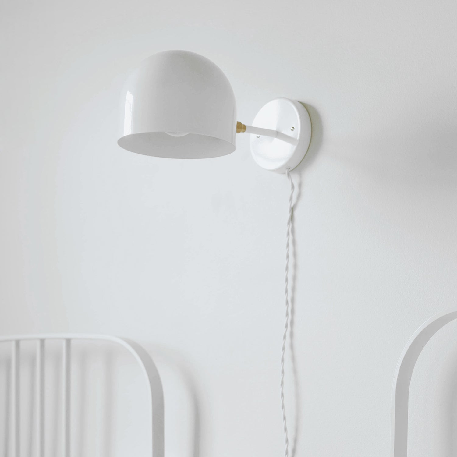 Amélie Sconce 8" shown in White with Brass with a White Twisted Cloth Cord. Interior Design by 41 Studios. Photo by Laura Palacios.