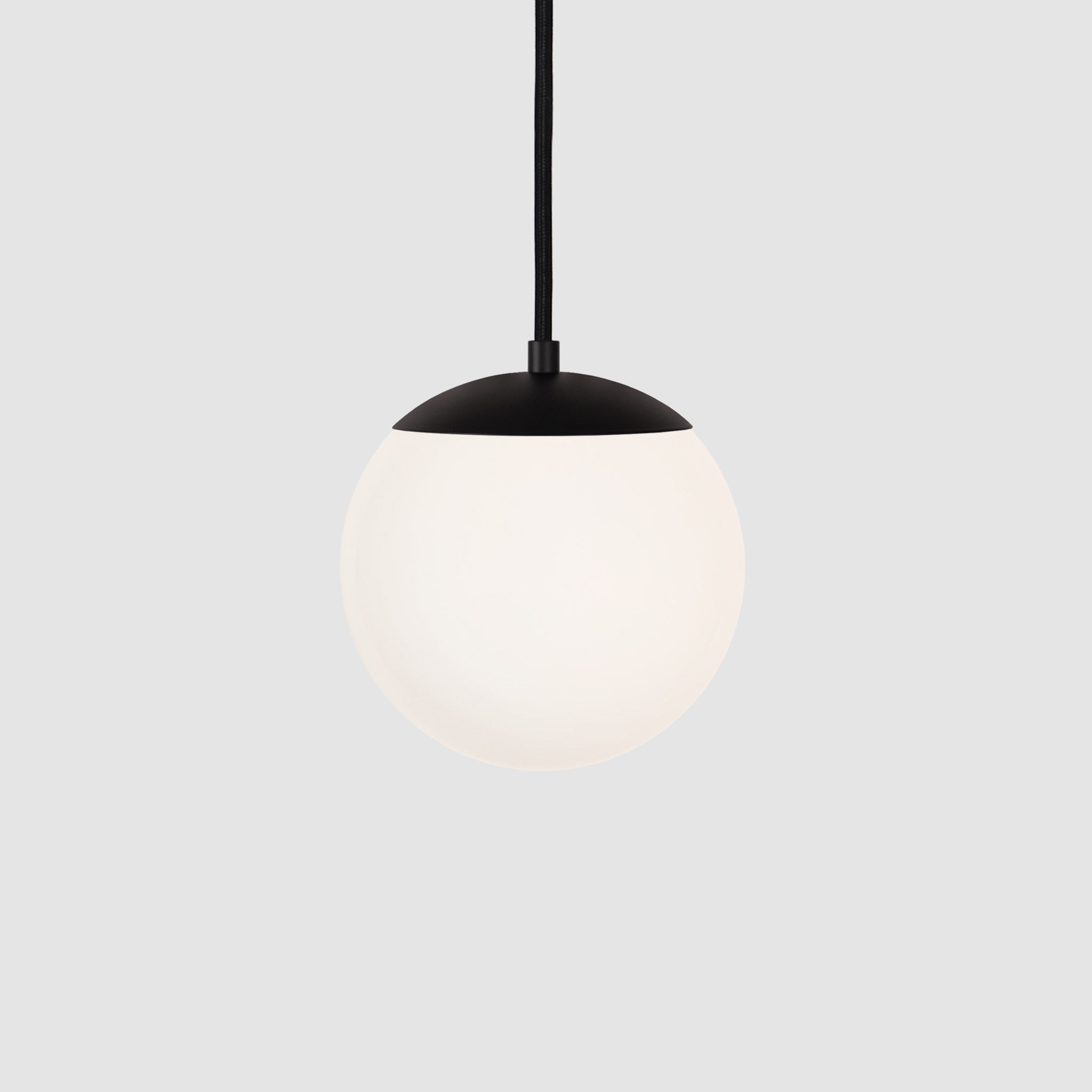 Alto Cord 8" shown in Matte Black with Black Cloth Cord and an Opal 8" Globe