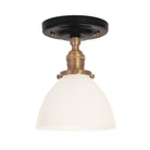Grace Surface shown in Heirloom Brass with a Gloss Black Ceramic canopy and an Opal Glass shade