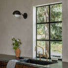Noor Curve Sconce shown in Matte Black