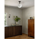 Sorbonne Surface 12" Globe shown in Graphite Patina with a Bijou Candle Wall Sconce