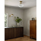 Sorbonne Surface 14" Tulip shown in Heirloom Brass with a Noor Curve Wall Sconce