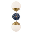 Theo shown in Heirloom Brass with an Indigo Blue Sunflower Ceramic Canopy