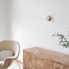 Brass Cutie Sconce shown in Heirloom Brass in a room