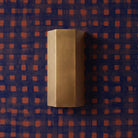Viviane ADA Sconce shown in Heirloom Brass with Thatcher Studio's Crosswise wallpaper