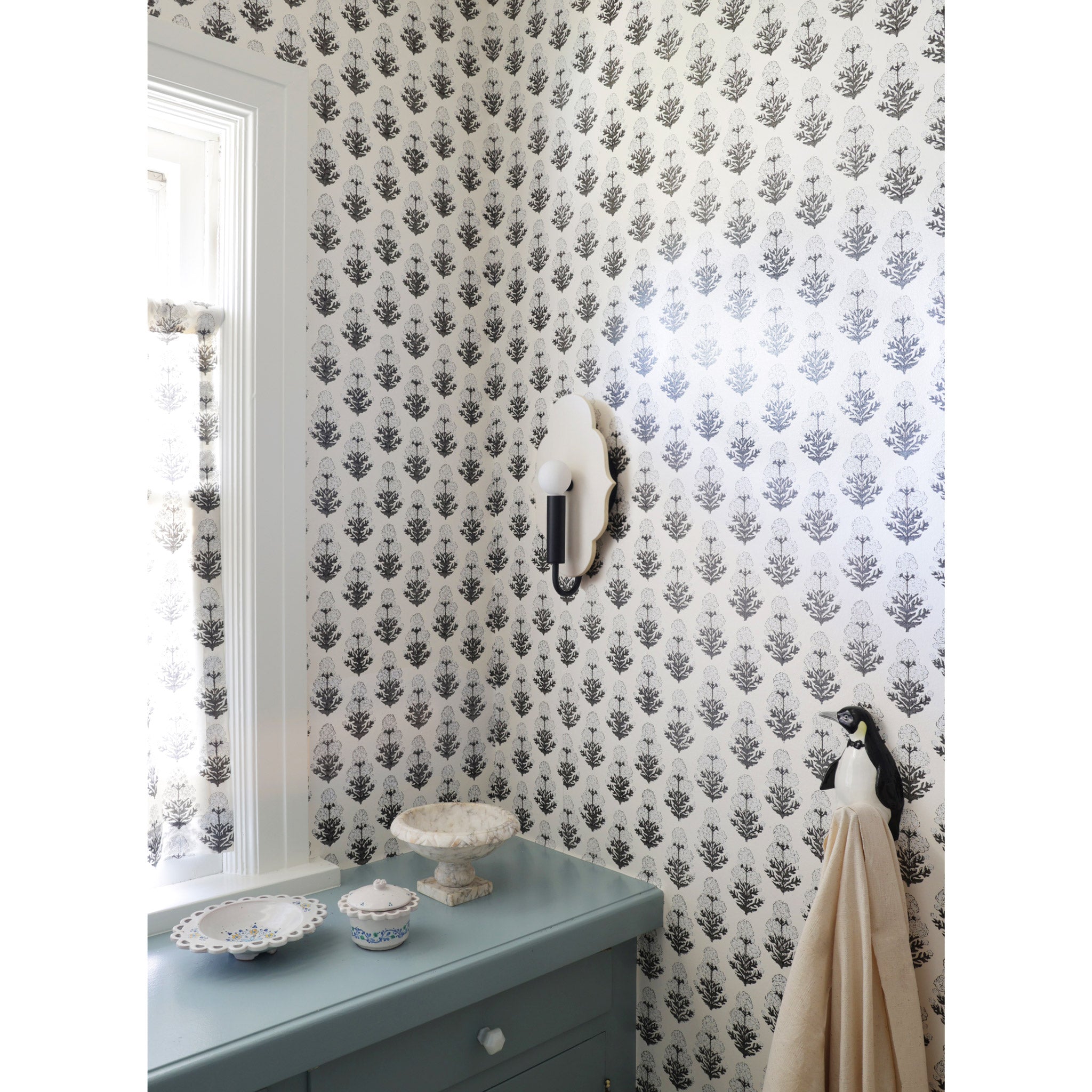 Clare Ceramic Sconce shown in Matte Black with a Natural White Glaze shown with Marigold wallpaper and fabric from Filling Spaces 