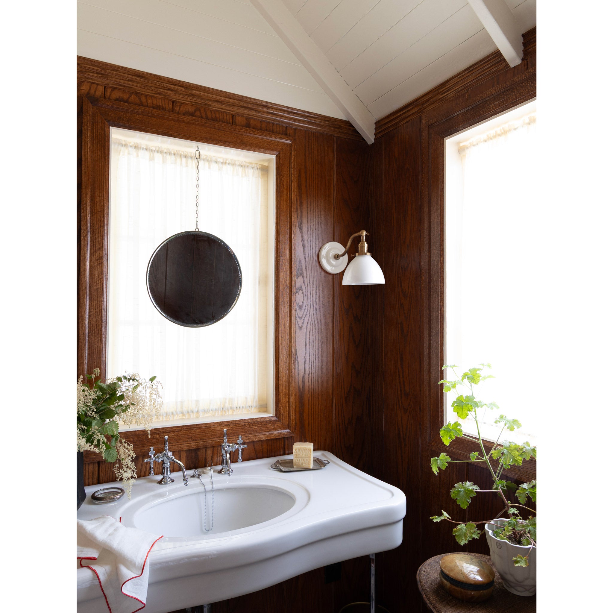 Grace Flush Sconce shown in Heirloom Brass with a Gloss White Ceramic canopy and Opal Glass shade. Interior design by Sarah J. Meyer Design