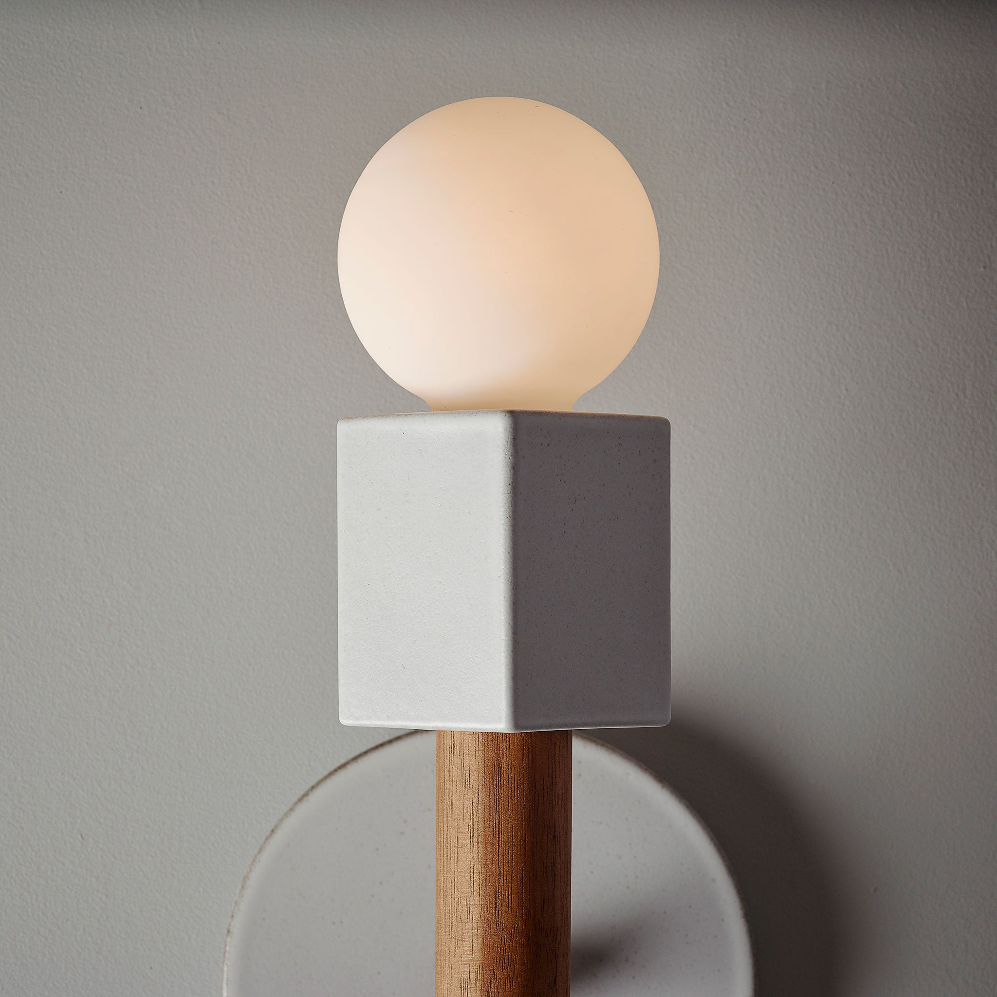 Seneca Sconce shown with a Swift Brownstone White ceramic canopy and Walnut