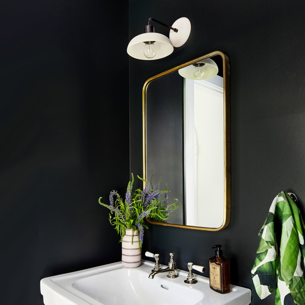 Terra Sconce shown in Bone ceramic finish with Matte Black metal. Interior Design by Zoe Feldman Design, Photo by Stacy Zarin Goldberg