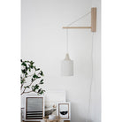 Tumwater 14" Wood Arm Sconce shown in Birch with a White Plug-in Cord. Interior Design by 41 Studios for Parachute Home. Photo by Belle + Whistle Studios.